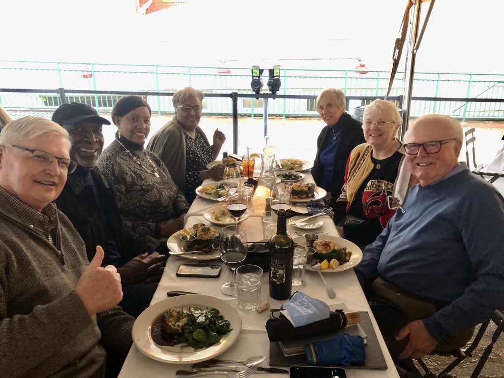 Community members sharing a meal and building connections at a Belonging Exchange dinner event.