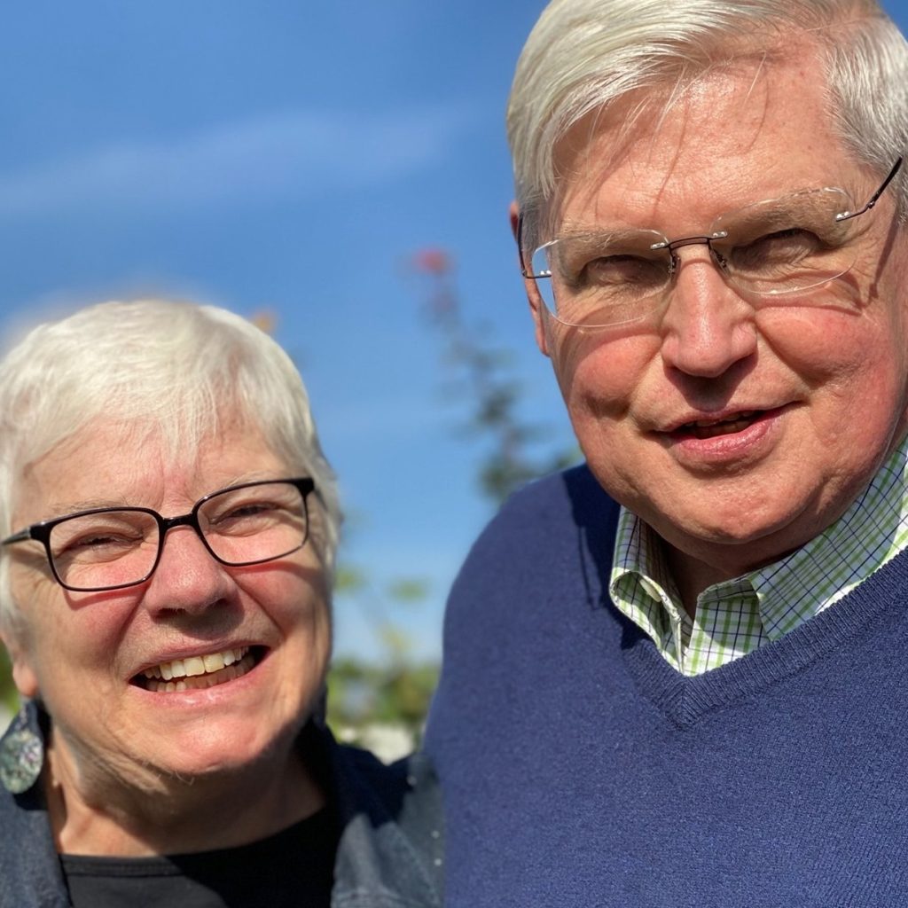 Philip and Elaine Amerson, smiling outdoors on a sunny day in Bloomington, Indiana.